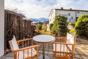 a table and chairs on a patio with a view at Casa La Prada in Flims