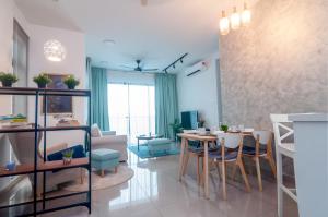 a living room with a table and chairs and a couch at Condo near Bukit Jalil by Idealhub in Kuala Lumpur