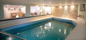 a large swimming pool in a building at PIEPers Landidyll Hotel in Bad Laer
