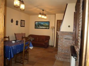 a living room with a table and a couch at La Currada in Taranes