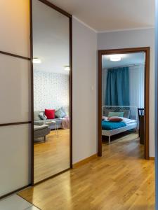 a living room with a mirror and a couch at Nozownicza Street Apartment in Wrocław