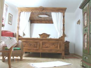 a wooden bed in a room with a window at Hotel Zur Erholung in Braunlage