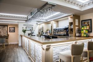 a bar in a restaurant with chairs around it at The H Boutique Hotel in Bakewell