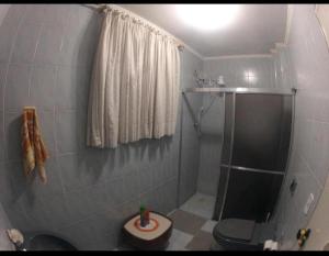uma pequena casa de banho com chuveiro e WC em Casa Gomes na Praia Grande