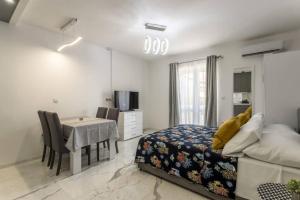 a bedroom with a bed and a desk and a table at Royal Platinum Studio Apartment in Vodice