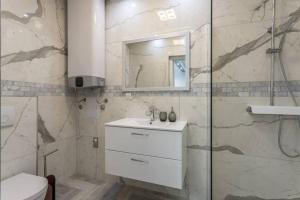 a bathroom with a shower and a sink and a toilet at Royal Platinum Studio Apartment in Vodice