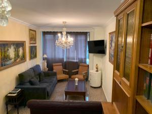 a living room with a couch and a table at Apartamentos Torr Av América - López de Hoyos - Chamartín in Madrid