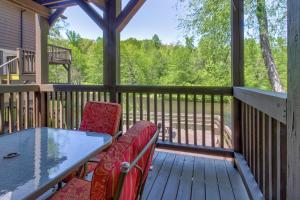 a screened porch with a table and chairs on a deck at Chattahoochee River Edge Condominiums in Helen