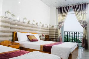 Giường trong phòng chung tại HIEP HOA HOTEL