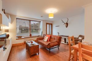 a living room with a couch and a table at Dundas Flat, 1 bedroom, Comrie in Comrie