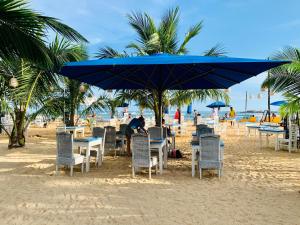 a beach area with chairs and umbrellas at Thaproban Beach House in Unawatuna