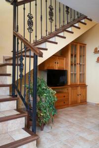 a living room with a staircase and a television at Casa El Correo in Puntallana