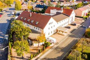 an aerial view of a large white building with a brown roof at Landgasthof Hotel Gentner in Nürnberg
