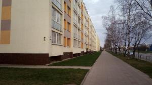 an empty sidewalk in front of a building at Bright apartment on top in Panevėžys
