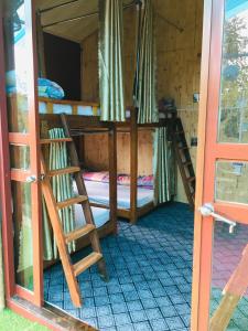 a room with two bunk beds and a window at Green Hill Hostel & Tour in Ha Giang
