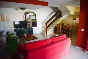 a living room with a red couch and a table at Lagaete Duplex in Agaete
