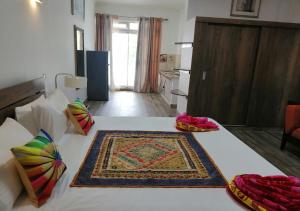 a room with a bed with a rug on it at Easy Stay Residence in Trou aux Biches