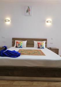 a bed with white sheets and pillows in a room at Easy Stay Residence in Trou aux Biches
