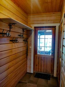 a wooden room with a door and a window at PyhäBerry in Pelkosenniemi