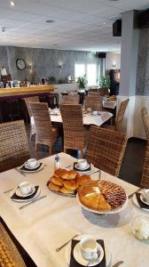 a table with bread and pastries on it in a restaurant at Hotel-Cafe Knoors-Meeks Stein Urmond in Berg +26 photos