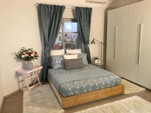 a small bedroom with a bed and a window at Dina's House in Spáta +80 photos