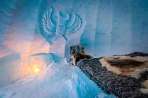 an ice castle with an owl on the side of it at Lucky Ranch Snow Igloos in Pyhätunturi