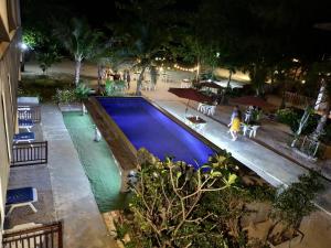 an overhead view of a swimming pool at night at Rimlay Bungalow in Nai Yang Beach