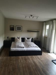 a bedroom with a bed with white sheets and pillows at Gästezimmer Ahornweg in Villingendorf