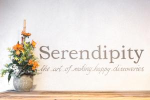 a white vase with flowers on a table at Serendipity Hotel in Sauze dʼOulx