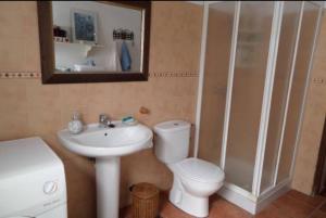 a bathroom with a toilet and a sink and a mirror at Marisa Home in Orzola +24 photos