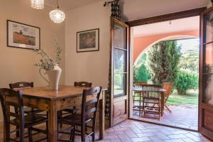 uma sala de jantar com uma mesa de madeira e cadeiras em Agriturismo Villa Toscana em Campiglia Marittima