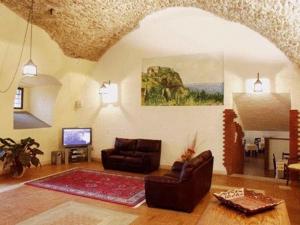 a living room with a couch and a television at Hotel Residence La Fortezza in San Lucido