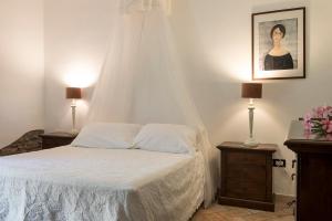 a bedroom with a bed and a dresser at Agriturismo Villa Toscana in Campiglia Marittima