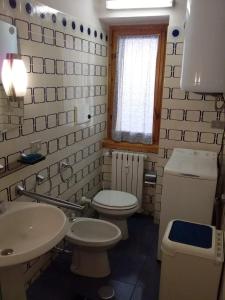 a small bathroom with a toilet and a sink at Monte Cervino apartment AS14 in Breuil-Cervinia