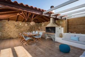 a kitchen and dining room with a table and a fireplace at Villa Georgia Heated Pool & Jet-Tub in Kolymvari