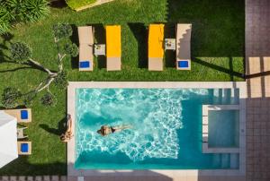 an overhead view of a pool with a person in the water at Villa Georgia Heated Pool & Jet-Tub in Kolymvari