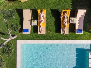 an overhead view of two women in bathing suits next to a swimming pool at Villa Georgia Heated Pool & Jet-Tub in Kolymvari