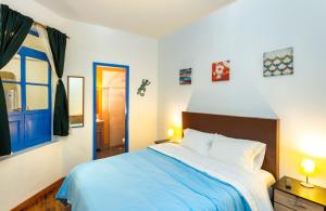 a bedroom with a blue bed and a blue door at Granada Hostel in Bogotá