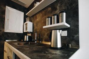 a kitchen with a sink and a counter top at Valletta Collection - Ordinance Suites in Valletta