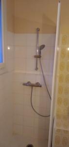 a shower with a shower head in a bathroom at chambre d'hôte in Campagne