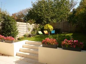 a garden with flowers in pots on a wall at Cape Cod in Wimereux
