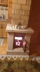 a fake fireplace in the middle of a kitchen at Jurmala's Center Eco House in Jūrmala