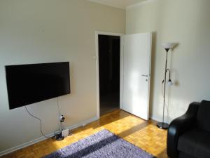 uma sala de estar com uma televisão de ecrã plano na parede em Autokomanda em Belgrado