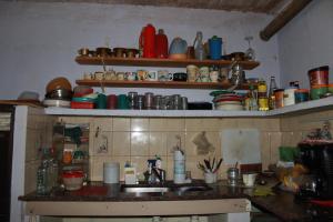 a kitchen with a sink and a counter with dishes at HOSTEL la Casa del Patio BB in Bahía Blanca