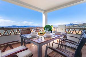 einen Tisch und Stühle auf einem Balkon mit Aussicht in der Unterkunft Holiday Home El Encinar in Alcaucín