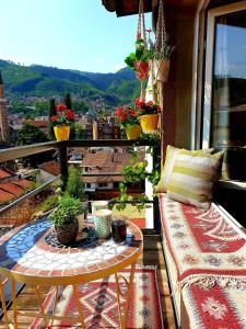 a balcony with a table and a view of a city at Apartment Noah in Sarajevo