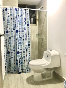 a bathroom with a toilet and a shower curtain at Caribbean Venture Apto 303 - Rodadero, Santa Marta in Santa Marta
