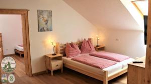 sypialnia z łóżkiem z czerwonymi poduszkami w obiekcie Kinderparadies Bachbauer w mieście Mondsee +37 zdjęć