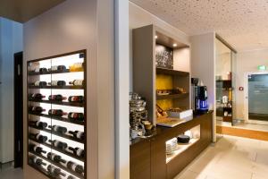 a room with a display case with wine bottles at hotel bomonti Nürnberg West in Oberasbach +37 photos