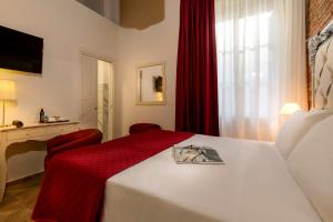 a hotel room with a bed with a red blanket at Le Stanze Dei Medici in Florence
